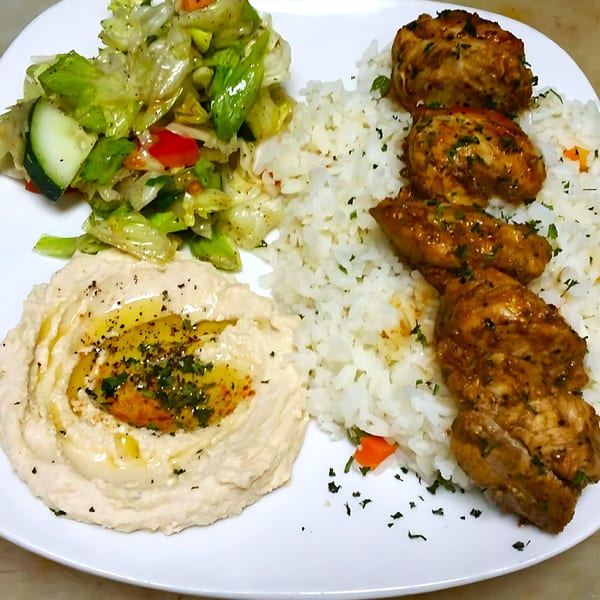Blue Olive Grill's Mediterranean plate with chicken, rice, hummus, and a side salad.